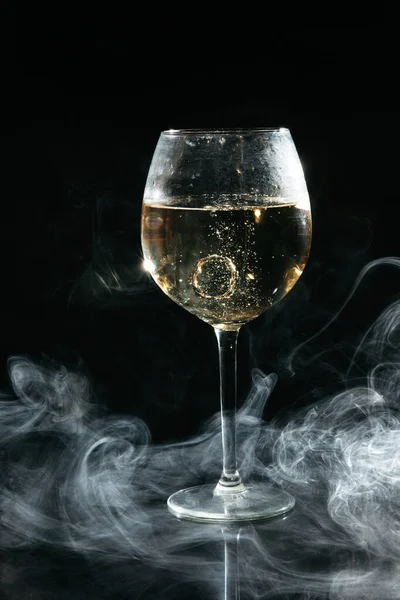 a ring in a glass of champagne, smoke