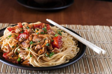 Spagetti domates soslu tavuk, domates, maydanoz üzerinde ahşap bir masa ile dekore edilmiş