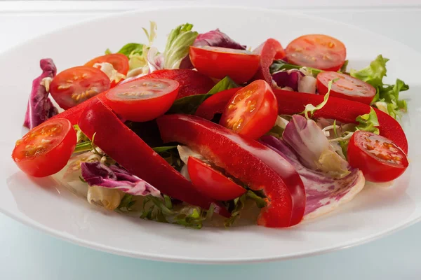 Salad with fresh vegetables on a white table — Stock Photo, Image