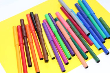 İşaretleyicileri masanın üzerinde dağınık vardır. Çoklu renk işaretleyicilerini çizim için. Çocuklar, okul, öğrenci ve ofis çalışanları çizmek.