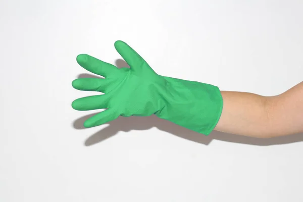 Rubber gloves are worn on the female hand. Hand on a white background.