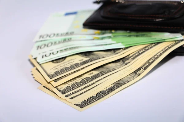 Currency in the wallet. The money is in a black wallet. Photo on a white background.