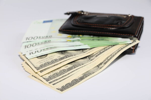 Currency in the wallet. The money is in a black wallet. Photo on a white background.