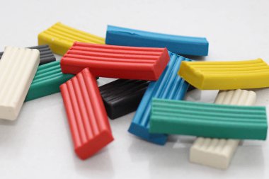 Beyaz bir arka plan üzerinde renkli parlak hamuru. Resim yaratıcı insanlar için. Yaratıcı gruplar parlak kil ile çalışma.