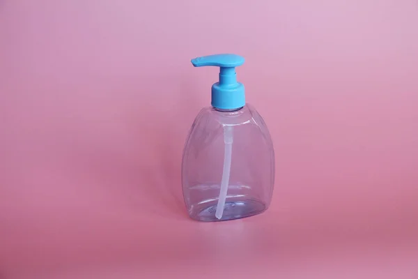 Ένα μπλε μπουκάλι σε ροζ φόντο. Μπουκάλι για καλλυντικά με αεροζόλ. — Φωτογραφία Αρχείου