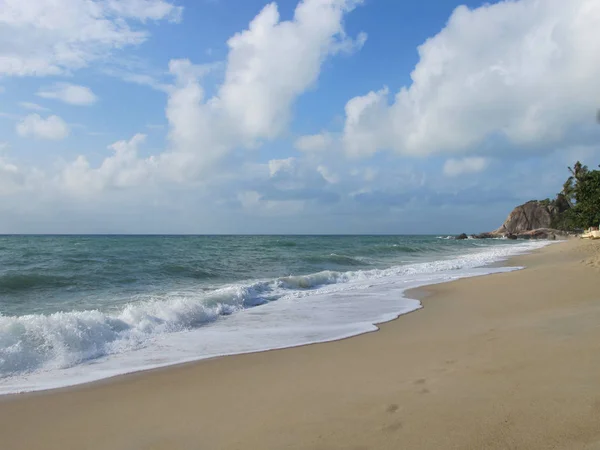 Turquoise sea and blue sky. There are beautiful clouds in the sky.