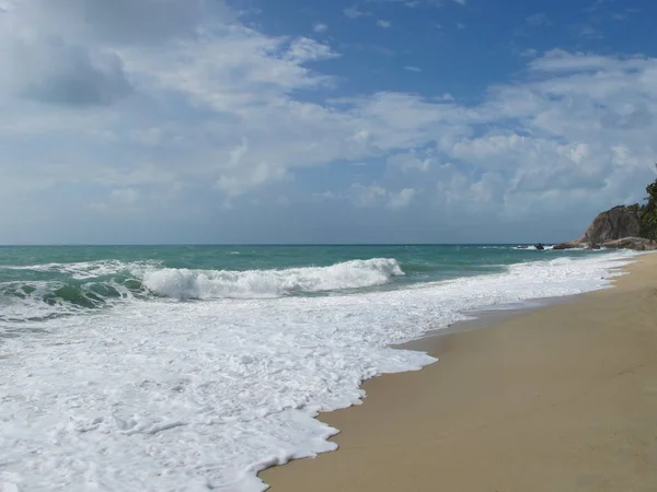 Turquoise sea and blue sky. There are beautiful clouds in the sky.