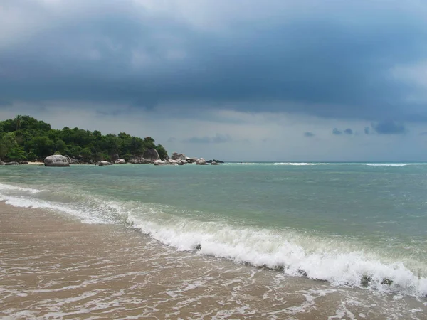 Turquoise sea and blue sky. There are beautiful clouds in the sky.