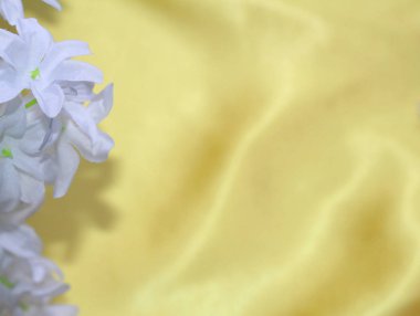 On the yellow material is a flower. The texture of the yellow material.