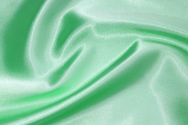 Yeşil malzemenin dokusu. Parlak yeşil ipek.