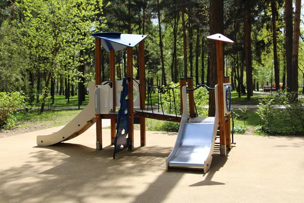 Playground for children in the park. Walking with children on the playground. — Stock Photo, Image