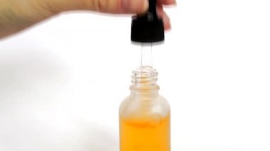 Şişe anti-aging sıvı. Cildi nemlendiren hyaluronik asitli serum. Güzel kadın el şişeden bir pipet çıkarır. Cilt bakımı için kozmetik kavramı.