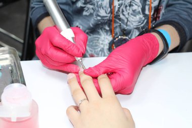 Hırdavat manikür. Tırnakların parmak tedavisi. Elektrikli tırnak dosyası iş başında.