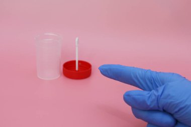 Doktorlar parmak, boş bir dışkı kabını işaret eder..