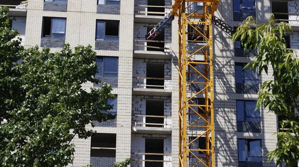 The construction of a new multi-storey building. Construction of a new frame energy-efficient home. Facade of a modern apartment. New buildings.