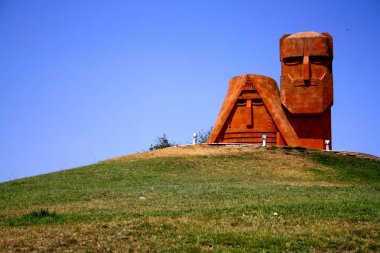 Nagorno-Karabakh, Armenia - August 23, 2014: Statue of grandparents at entrance of unrecognized republic which Armenians call Artsakh.  clipart