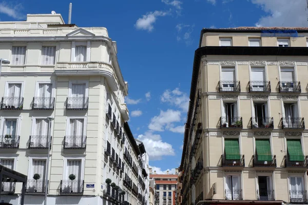 Classical facades of two parallel houses in Fuencarral street, downtown of Madrid