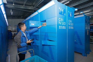 A Chinese worker sorts out parcels at a station of Cainiao Network, the logistics arm of Chinese e-commerce giant Alibaba, in Donghua University in Shanghai, China, 13 November 2018 clipart