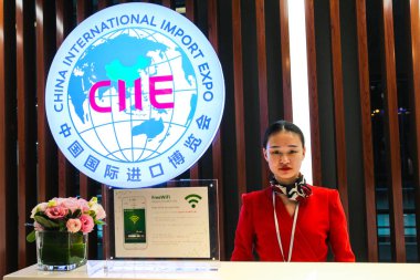 A Chinese hostess poses in the China International Import Expo Service Center at the Shanghai Hongqiao International Airport in Shanghai, China, 23 October 2018 clipart
