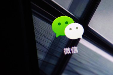Chinese mobile phone user uses the messaging app Weixin, or WeChat, of Tencent, on his smartphone in Ji nan city, east China Shandong province, 27 July 2018 clipart