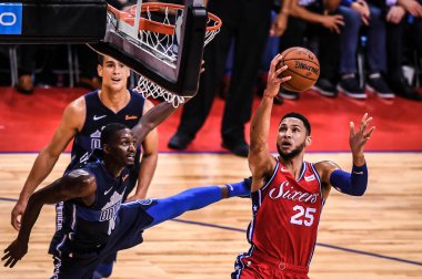 Ben Simmons of Philadelphia 76ers, right, jumps to score against Dallas Mavericks during the Shenzhen match of the NBA China Games in Shenzhen city, south China's Guangdong province, 8 October 2018 clipart