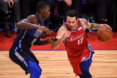 JJ Redick of  Philadelphia 76ers, right, challenges Dorian Finney-Smith of Dallas Mavericks during the Shenzhen match of the NBA China Games in Shenzhen city, south China's Guangdong province, 8 October 2018 clipart