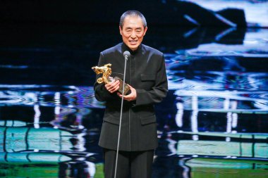 Chinese director Zhang Yimou speaks after being awarded with the trophy of the Best Director for his movie 