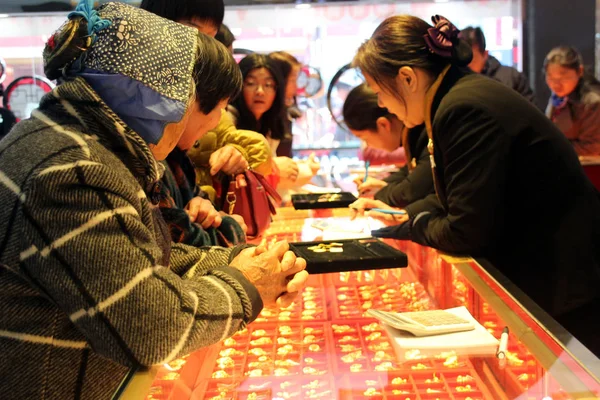 中国の顧客は 中国東部の江蘇省蘇州市の宝石店で金の装飾品を買い物をする 2017年10月4日 — ストック写真