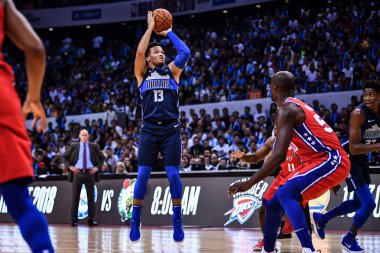 Jalen Brunson of Dallas Mavericks jumps to shoot against Philadelphia 76ers during the Shenzhen match of the NBA China Games in Shenzhen city, south China's Guangdong province, 8 October 2018 clipart