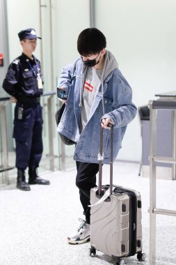 JackeyLove of Invictus Gaming, winning the League of Legends World 2018 Championship in Inchon, arrives at the Shanghai Hongqiao International Airport before departure in Shanghai, China, 5 November 2018 clipart