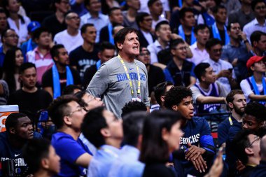Mark Cuban, center, the owner of Dallas Mavericks, reacts bedore the Shenzhen match of the NBA China Games between Dallas Mavericks and Philadelphia 76ers in Shenzhen city, south China's Guangdong province, 8 October 2018 clipart