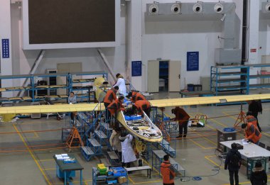 Chinese workers assemble a Wing Loong unmanned aerial vehicle (UAV) at the assembly plant of AVIC Chengdu Aircraft Design and Research Institute in Chengdu city, southwest China's Sichuan province, 24 January 2018 clipart