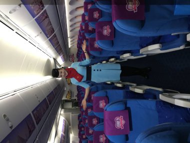 A Chinese crew member poses in an Boeing 787-9 jet plane to run on the newly-opened direct flight between Paris and Fuzhou of Xiamen Airlines at the Fuzhou Changle International Airport in Fuzhou city, southeast China's Fujian province, 10 December 2 clipart