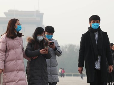 Chinese tourists wearing face masks against air pollution visit the Tiananmen Square in heavy smog in Beijing, China, 26 November 2018 clipart