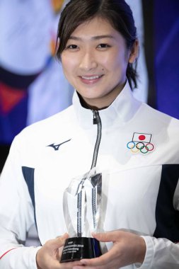 Japanese swimmer Rikako Ikee poses with the trophy after she was named the Olympic Council of Asia's Most Valuable Player at the 2018 Asian Games, officially known as the 18th Asian Games and also known as Jakarta Palembang 2018, in Jakarta, Indonesi clipart