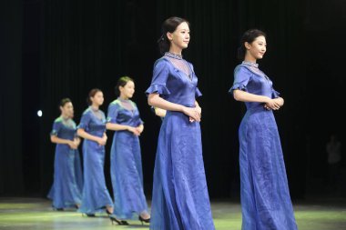 Chinese volunteers wearing cheongsam (qipao) attend the launching ceremony for the Fifth World Internet Conference (WIC), also known as Wuzhen Summit, in Wuzhen town, Tongxiang, Jiaxing city, east China's Zhejiang province, 1 November 2018 clipart