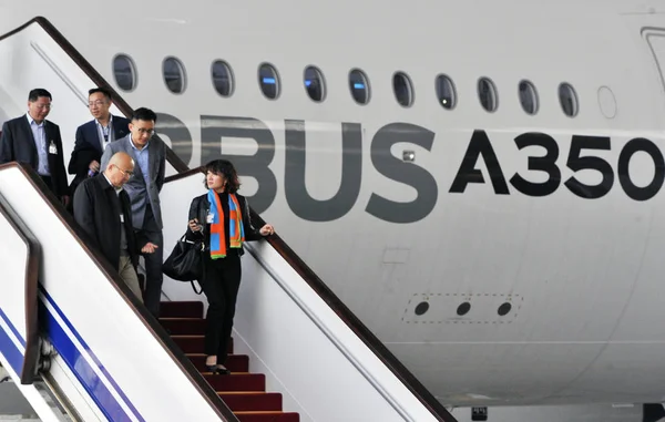 Visitors stand next to a turbofan jet of ZYB Lily Jet on display during the  Asian Business Aviation Conference and Exhibition 2013, known as ABACE 201  Stock Photo - Alamy