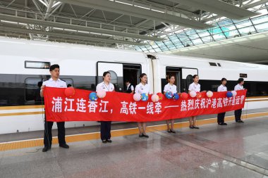 Train staffs of train G99, the first high-speed train from Shanghai to Hong Kong, pose for a group photo at Hongqiao Railway Station in Shanghai, China, 23 September 2018 clipart