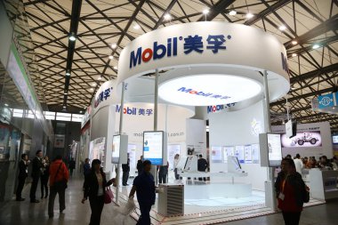 Chinese employees are seen at the stand of US oil giant ExxonMobil Corp during an expo in Shanghai, China, 25 November 2014 clipart