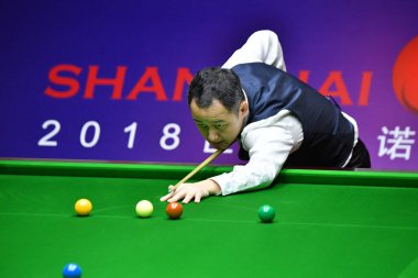 Guo Hua of China plays a shot to Neil Robertson of Australia in their first round match during the 2018 Shanghai Masters snooker tournament in Shanghai, China, 10 September 2018 clipart