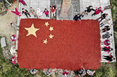 Aerial view of a giant national flag created by Chinese farmers using eight tons of freshly-harvested peppers and corn on the top of Longquan Mountain in Lishui city, east China's Zhejiang province, 26 September 2018 clipart