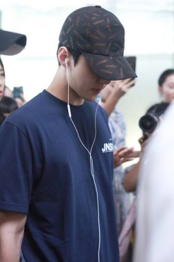 South Korean singer and actor Oh Se-hun, better known mononymously as Sehun, of South Korean boy group EXO arrives at the Beijing Capital International Airport in Beijing, China, 20 July 2018. clipart