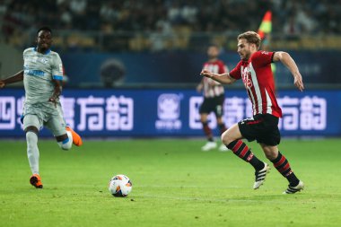 Shane Long of Southampton F.C. dribbles against FC Schalke 04 in a friendly match between FC Schalke 04 and Southampton F.C. during the 2018 Clubs Super Cup in Kunshan city, east China's Jiangsu province, 4 July 2018. clipart