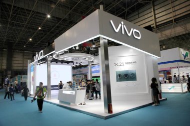 People visit the stand of Vivo during an expo in Dongguan city, south China's Guangdong province, 19 April 2018 clipart