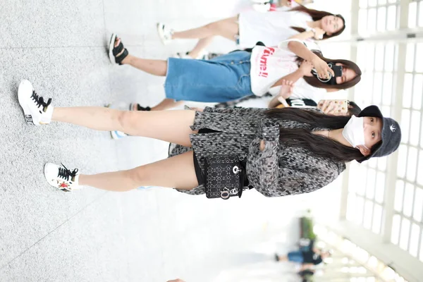 Taiwanese singer Jolin Tsai dressed in a Uniqlo Doraemon X Takashi Murakami  UT is pictured at the Beijing Capital International Airport in Beijing, Ch  Stock Photo - Alamy