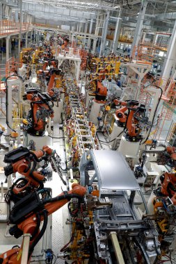 Cars are being assembled on the assembly line at the auto plant of Belgee, the joint venture between Belarus and Chinese carmaker Geely that produces Belarussian-made vehicles targeting the Russian market in Borisov, Belarus, 5 July 2018 clipart