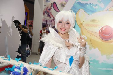 A showgirl dressed in cosplay costume poses during the 14th China International Cartoon & Game Expo (CCG Expo 2018) in Shanghai, China, 5 July 2018 clipart