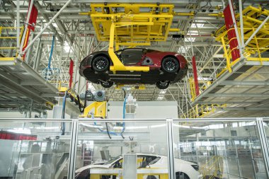 Qiantu K50 electric roadsters are assembled on the assembly line at the auto plant of Qiantu Motor in Suzhou city, east China's Jiangsu province, 8 August 2018 clipart
