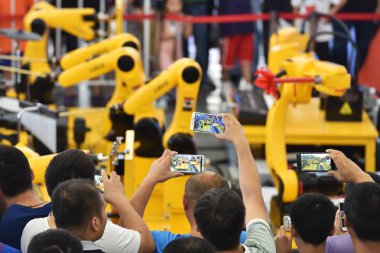 An industrial robot of a band self-developed by Gree Electric performs during the World Robot Conference (WRC) 2018 in Beijing, China, 15 August 2018 clipart