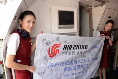 Flight attendants pose in a business-class cabin of an Airbus A350-900 jet plane of Air China after it arrived at the Chengdu Shuangliu International Airport in Chengdu city, southwest China's Sichuan province, 15 August 2018 clipart